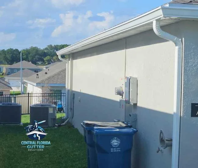 "New white seamless gutter and downspout installation on a Central Florida residential home."